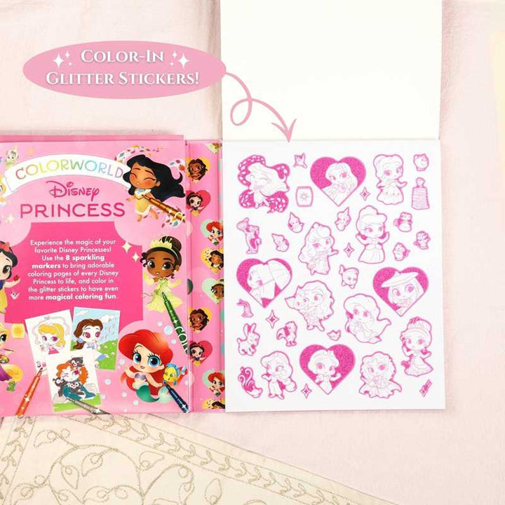 A Colorworld: Disney Princess coloring book by Editors of Studio Fun International, published by Simon &amp; Schuster, is open to reveal glitter stickers featuring beloved princesses and a vibrant cover page filled with colorful princess illustrations and crayons on a pink surface—an ideal set for pairing with metallic markers to add extra sparkle to your Disney Princess coloring kit.