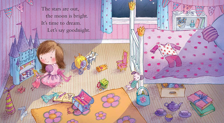 A little girl in pajamas sits in her colorful, toy-filled bedroom at night with Goodnight Princess by Sourcebooks beside her. On the wall: “The stars are out, the moon is bright. It’s time to dream. Let’s say goodnight.” A sweet bedtime moment.