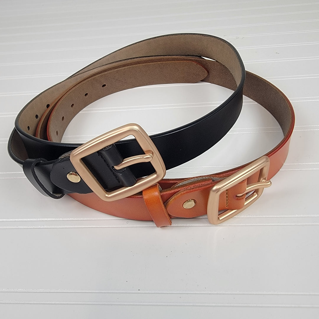 Two Brass Buckle Belts by Leto Collection—one black, one brown—feature gold square brass buckles and adjustable fits. The belts are coiled together on a white, textured surface.
