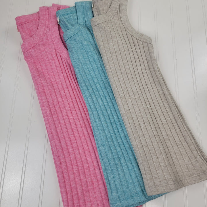The Zenana Bridget Tank Top is shown in pink, blue, and beige, laid side by side on a white wooden surface—perfect for summer layering or as a stylish alternative to your favorite fitted tank.