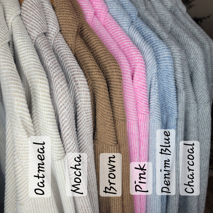 Seven Gracie Shackets by Timing in oatmeal, mocha, brown, pink, denim blue, and charcoal hang side by side, each with its color name on a clear tag—showcasing the stylish button front collection.