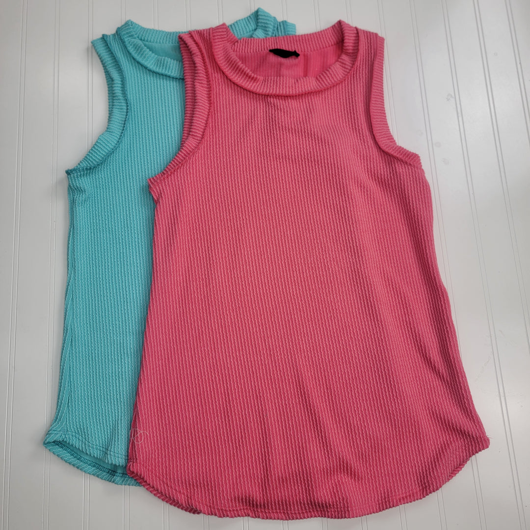 Two Heimish Ollie Tank Tops, one turquoise blue and one bright pink with exposed seams, are laid flat on a white surface. Made from stretchy ribbed knit with round necklines, the pink top partially overlaps the blue.