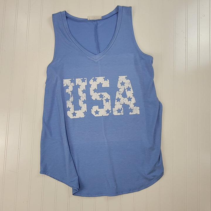 The USA Graphic V-Neck Tank by Cosmos + Clover Boutique is a plus size, sleeveless blue top with bold white "USA" lettering and stars, shown on a white vertically paneled background.