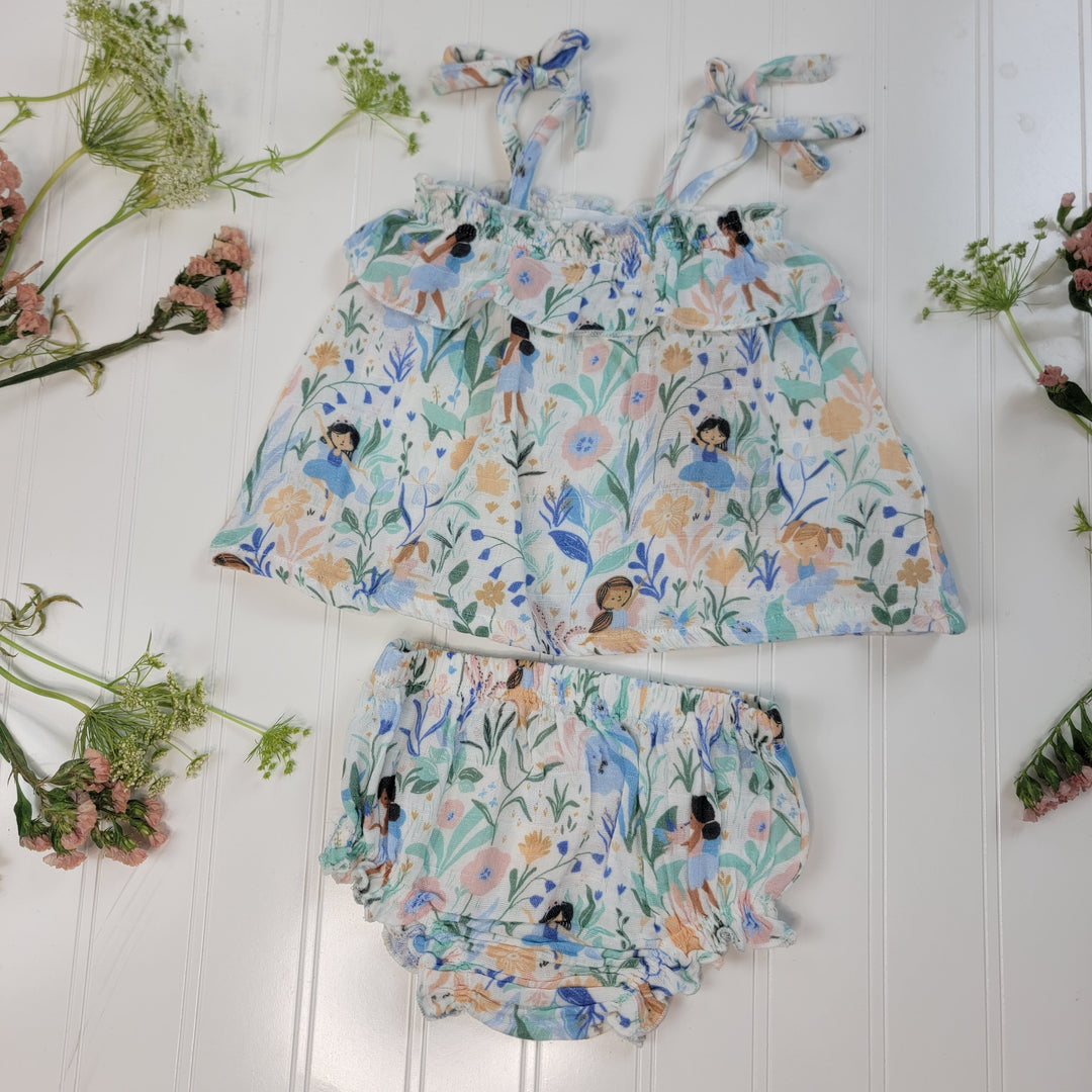 The Angel Dear Summer Baby Clothes set features a sleeveless top with shoulder ties and matching bloomers in a floral pattern, displayed flat on a white surface with pink and green flowers and greenery.