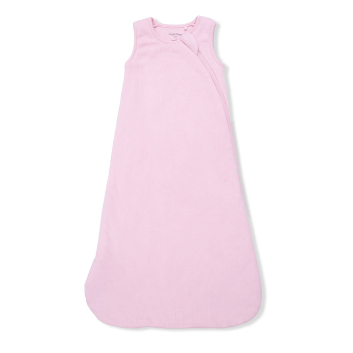 The Angel Dear Solid Romance Rose Rib Sleep Bag, a sleeveless and light pink baby sack with soft ribbed modal fabric, side zipper, and rounded bottom, is shown laid flat on a white background.
