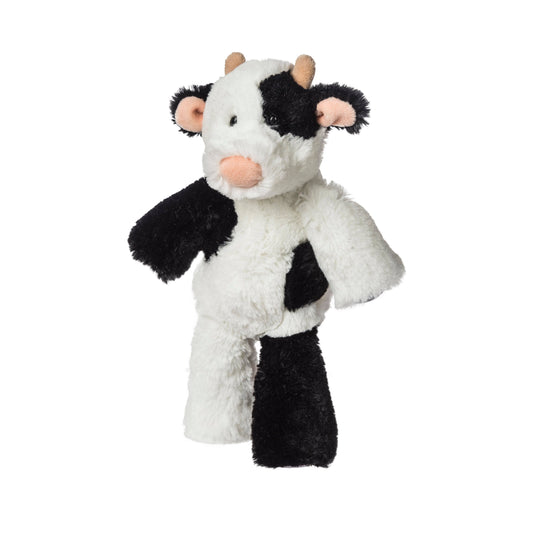 The Mary Meyer Marshmallow Junior Clyde Cow is a plush toy with black and white fur, light brown horns, and a pink snout—a cuddly weighted plush that stands upright and makes a perfect addition to any soft toy collection.