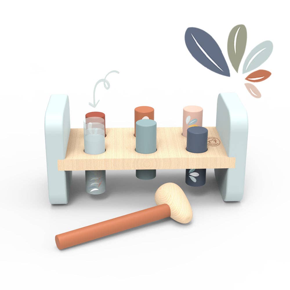 Crafted from child-safe, FSC Certified wood, the Speedy Monkey Hammer Bench is a charming wooden toy featuring colored pegs, a mallet, and delicate floral designs. The pegs fit snugly into a light wood base with pastel blue sides, while a matching floral pattern above the toy adds an extra touch of whimsical style.