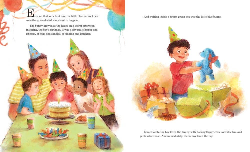 At a birthday party, children in party hats gather around a cake as a smiling boy opens a gift to reveal Little Blue Bunny (HC picture book) by Sourcebooks, capturing childhood nostalgia among presents and decorations.