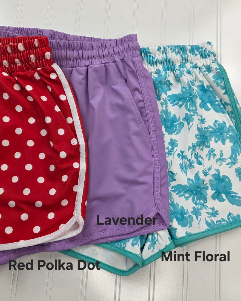 Jess Lea’s Everyday Shorts in Bright and Playful Patterns for Summer come in Red Polka Dot, Lavender, and Mint Floral. Each pair features an elastic waistband for comfort and a relaxed fit—perfect for casual wear.