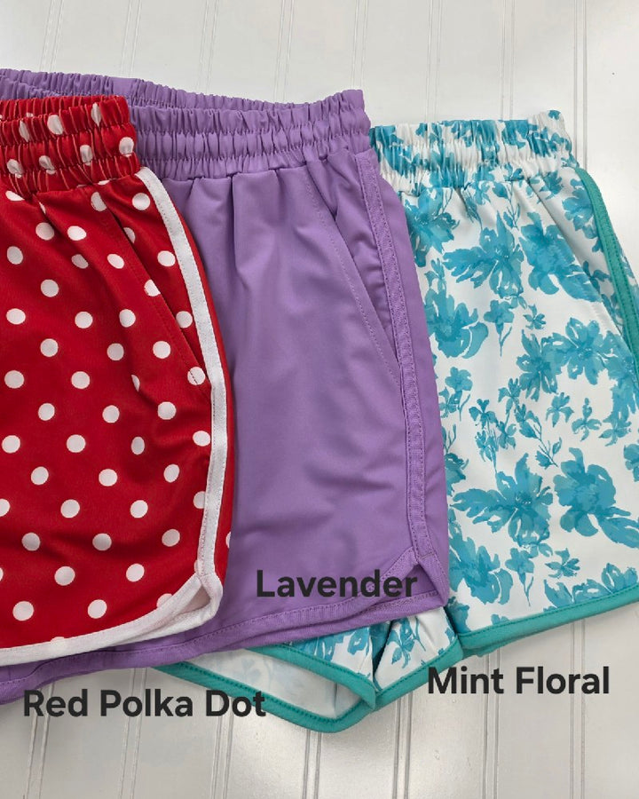 Jess Lea’s Everyday Shorts in Bright and Playful Patterns for Summer come in Red Polka Dot, Lavender, and Mint Floral. Each pair features an elastic waistband for comfort and a relaxed fit—perfect for casual wear.