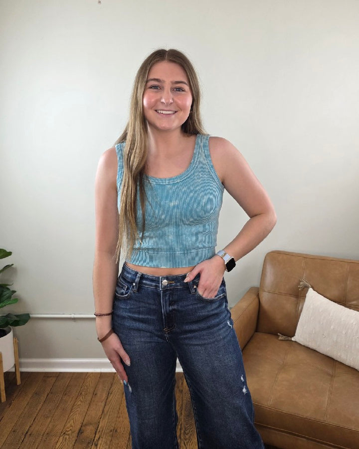 Woman standing in a living room in wide leg cropped jeans and the Kaitlyn ribbed cropped tank top from Cosmos and Clover Boutique