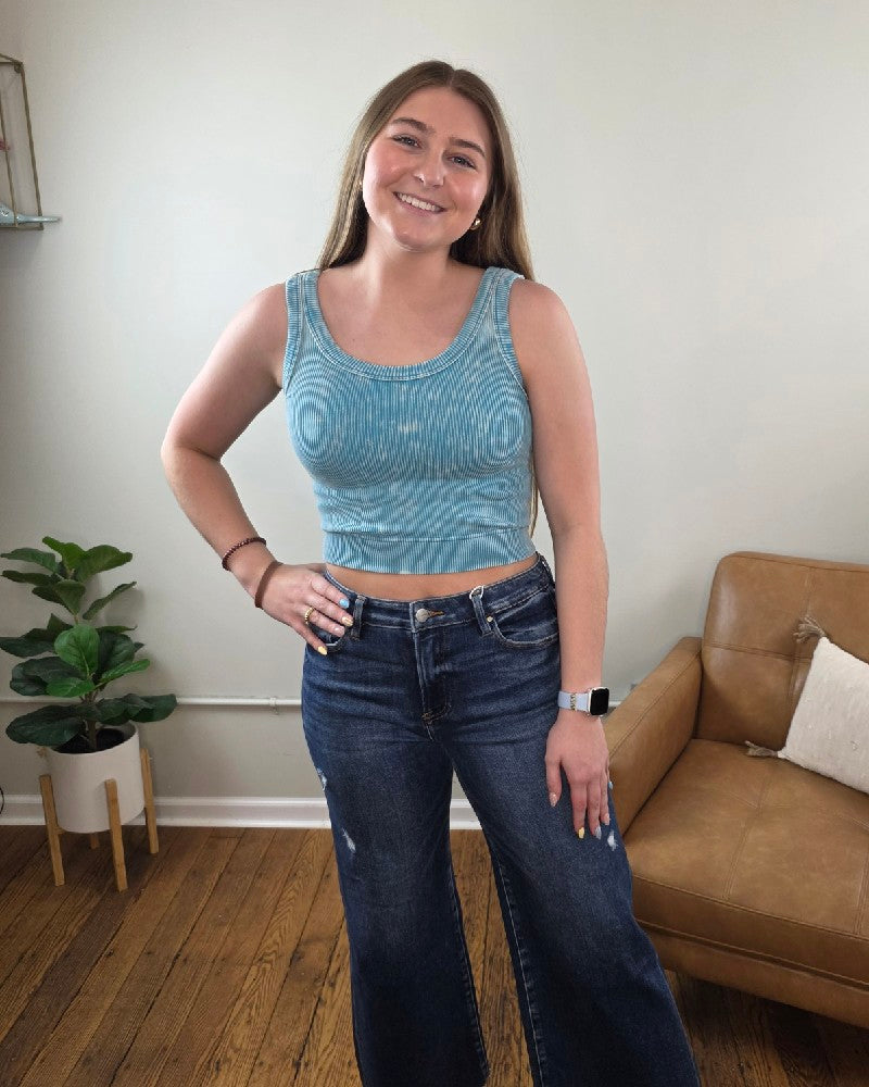 Woman standing in a living room in wide leg cropped jeans and the Kaitlyn ribbed cropped tank top from Cosmos and Clover Boutique