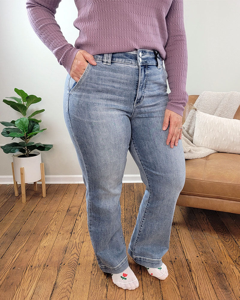 A person wearing Julia Wide Leg Jeans from Judy Blue and a purple sweater.