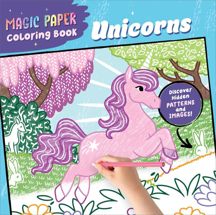 A hand colors a purple unicorn in the Sourcebooks Magic Paper Coloring Book: Unicorns, which features trees, animals, and a note saying "Discover hidden patterns and images!"—an enchanting coloring book filled with hidden pictures waiting to be revealed.