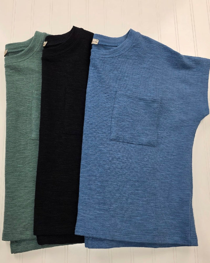 Three Amanda Boxy Fit Cropped Tees with Pocket by ZENANA in green, black, and blue are laid flat side by side on a white surface. Each features a classic crew neckline and relaxed silhouette for effortless everyday style.