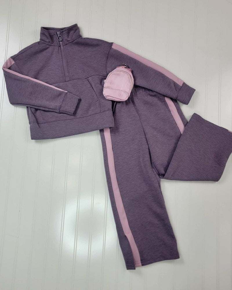 Audra Little Girls Half Zip, Straight Pants and Mini Bag Set featuring a purple long-sleeve top with matching straight-leg pants, light pink side stripes, and a coordinating small pink backpack.