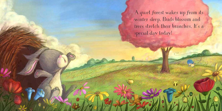 A gray bunny stretches and yawns beside colorful flowers. A pink tree stands in a green field under a bright sky. Text reads: A quiet forest wakes up from its winter sleep... It’s a special day today! Discover the magic of the season with Easter Egg Hunt for Jesus by Susan Jones from Simon &amp; Schuster—a heartwarming Easter book for kids, perfect for sharing the meaning of Easter and inspiring an Easter egg hunt adventure.