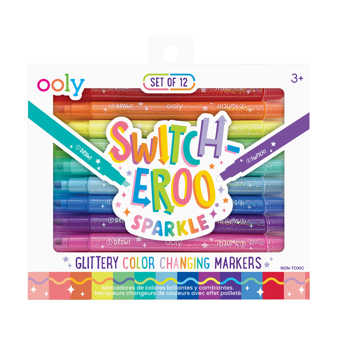 A box of OOLY Switch-Eroo Sparkle Glittery Color Changing Markers (12 pc), with shimmery markers visible through the package and playful, multicolored front text. Suitable for ages 3+.