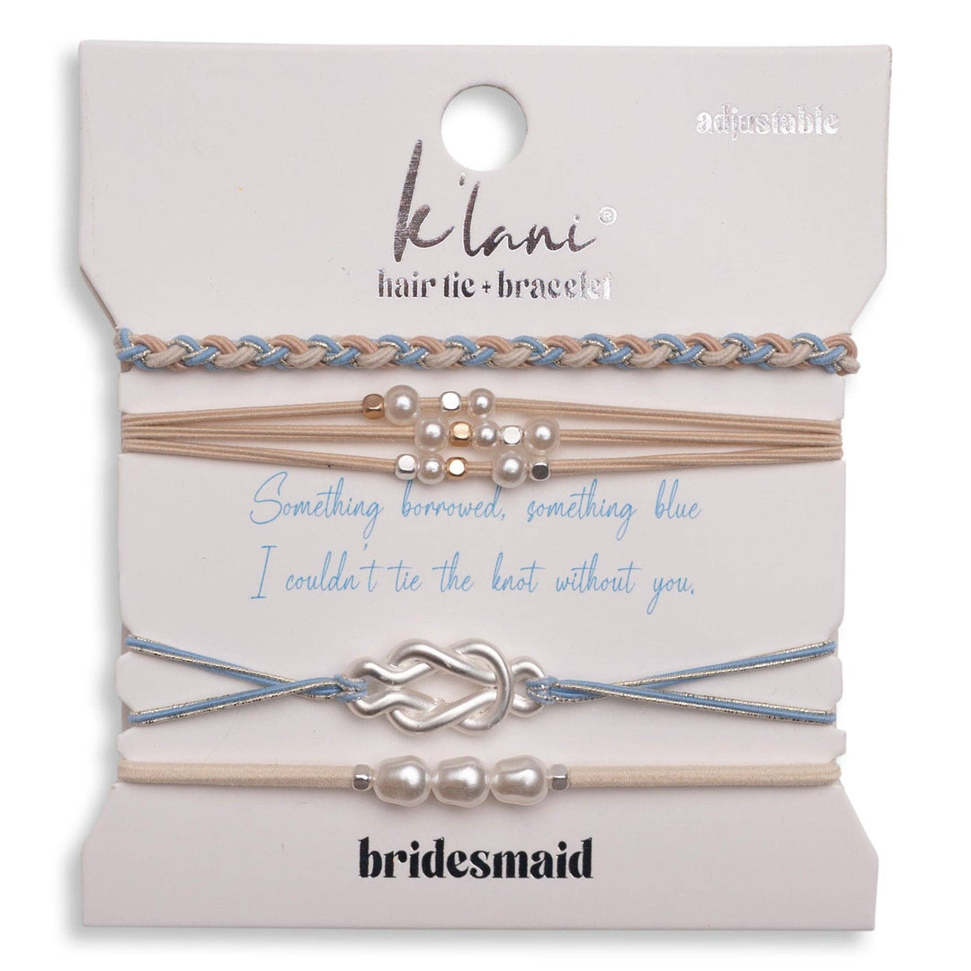 A set of four K’lani “Bridesmaid” cream and blue adjustable hair tie bracelets with pearl accents makes a thoughtful bridesmaid gift, each presented on a card reading “Something borrowed, something blue. I couldn’t tie the knot without you.”.