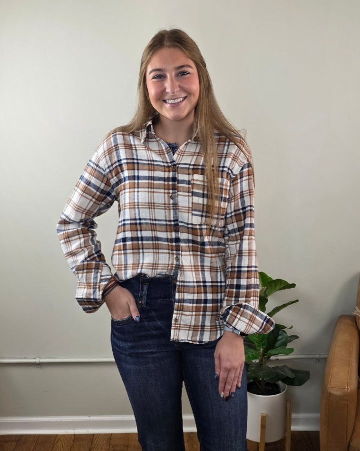 A woman smiles while wearing a brown Kimberly Plaid Flannel Long Sleeve shirt.