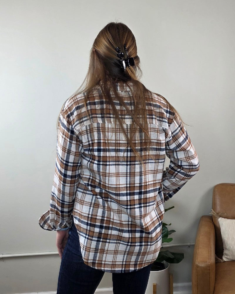 A person seen from behind wearing a brown, blue, and white Kimberly Plaid Flannel Long Sleeve shirt.