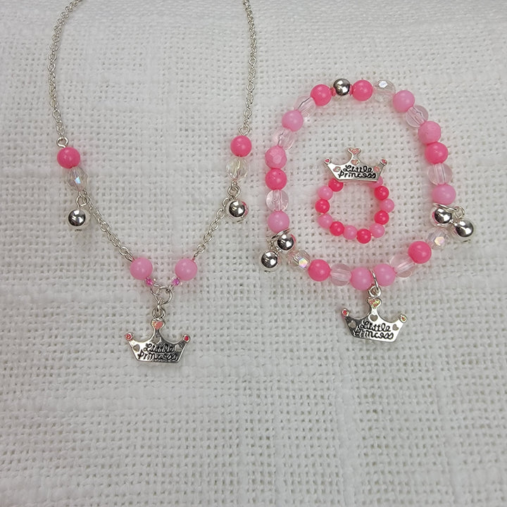The 2HOPE Accessories, Inc Girls Charm Jewelry: 3 pc Sets includes a necklace, bracelet, and ring with Daddy's Princess crown charms and pink beads, displayed on a white textured surface.